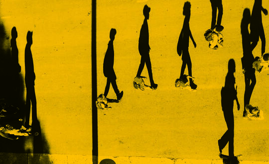 People walking, office commute, reflection in building