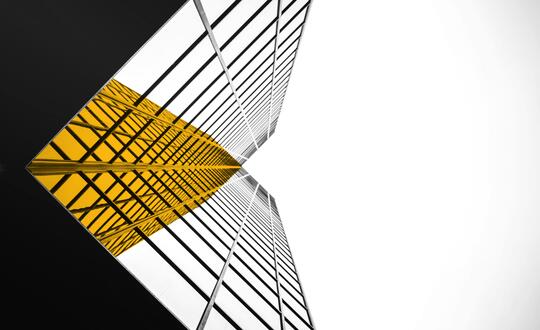 Upwards shot of corporate building with yellow highlight