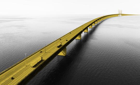 Photo of bridge over river with cars and lorries driving over it. Bridge is edited with a yellow highlight.