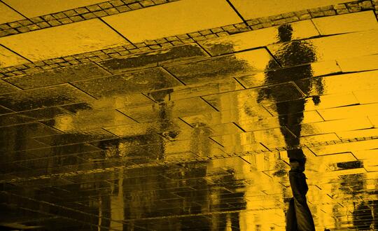 Rain reflection of man walking