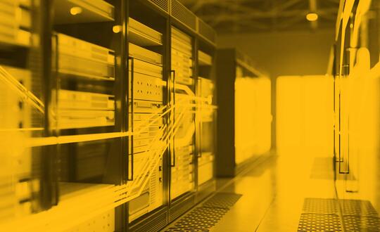 Picture of a server room. Image edited with yellow wash.