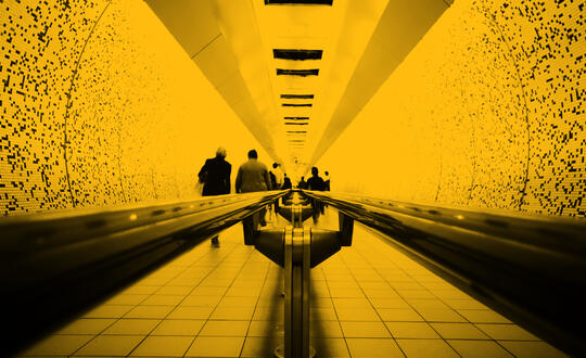 People walking down tunnel