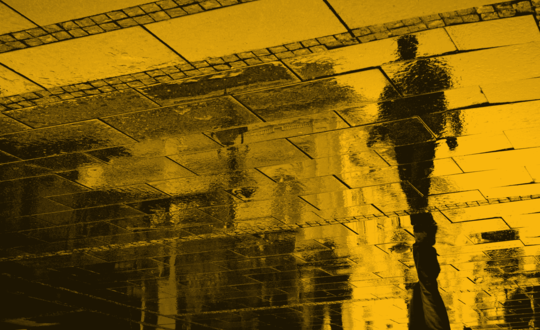 Reflection of person in puddle