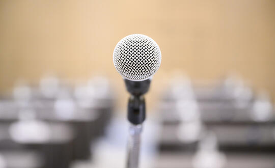 Microphone in front of rows of chairs