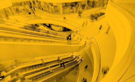 People travelling up escalator