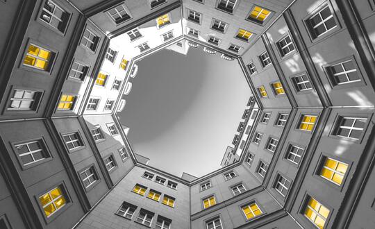 Upwards shot of circle of flat buildings