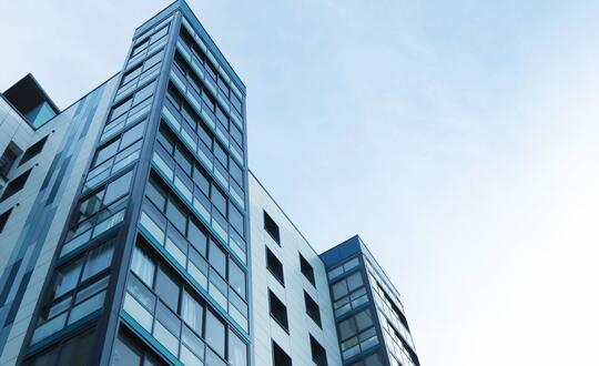 Apartment block with a blue sky background